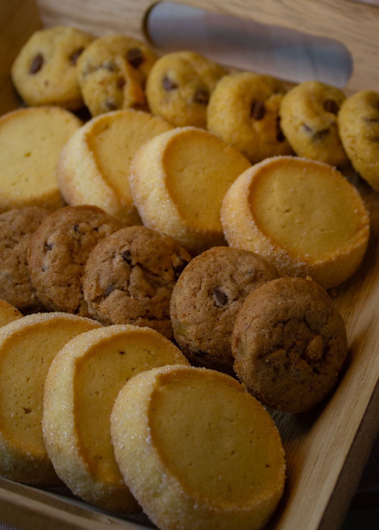 Freshly baked assorted cookies on a rustic wooden table